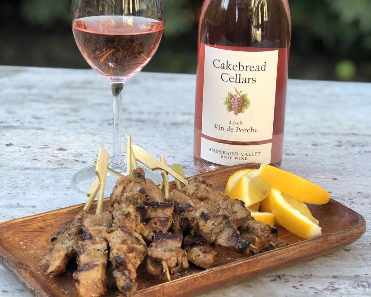 Delicious Spanish pork skewers served with lemon wedges and a glass of rosé wine from Cakebread Cellars. Perfect pairing for.