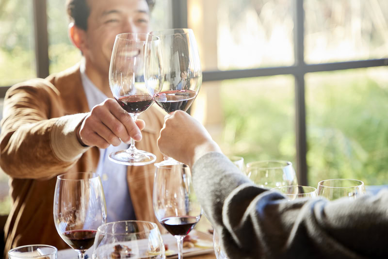 People clinking wine glasses during a tasting at Cakebread Cellars in Napa Valley.