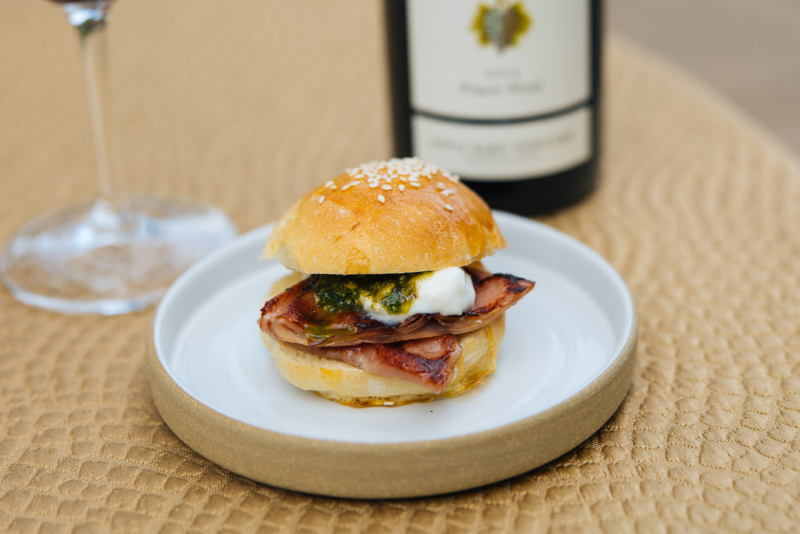 Fried bologna slider on a white plate and yellow tablecloth