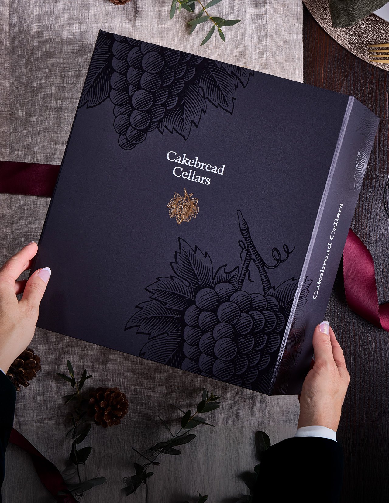 Elegant dark blue Cakebread Cellars gift box with grapevine design, perfect for holiday gifting and wine lovers.